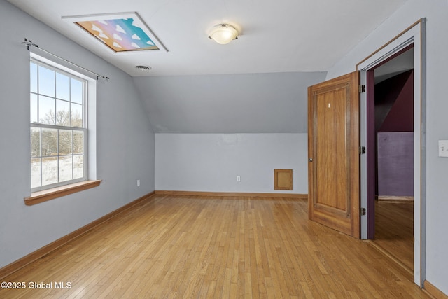 additional living space with lofted ceiling and light hardwood / wood-style floors