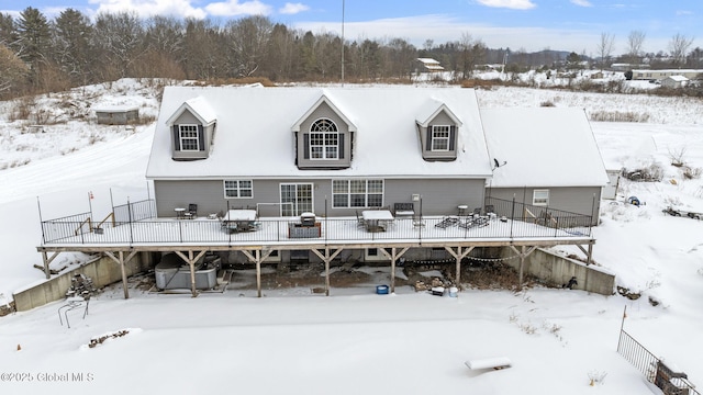 snow covered property featuring a wooden deck