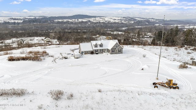 snowy aerial view with a mountain view