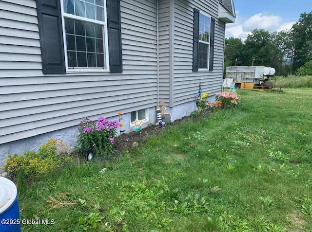 view of side of property with a lawn