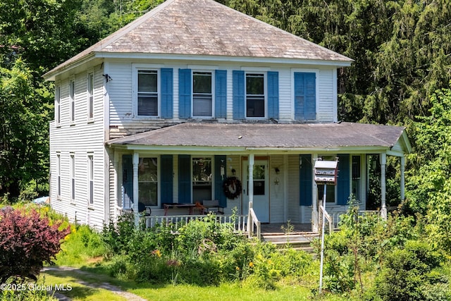 1673 County Route 64, Salem, NY 12865 - view of front of property with covered porch, a shingled roof, and a view of trees