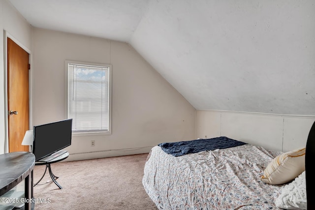 bedroom with lofted ceiling and carpet