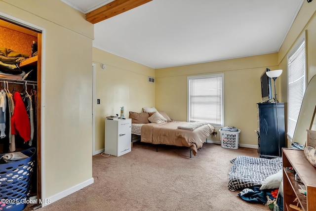 bedroom with carpet flooring, a closet, and a spacious closet