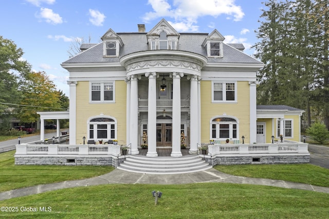 neoclassical / greek revival house with a front yard and french doors