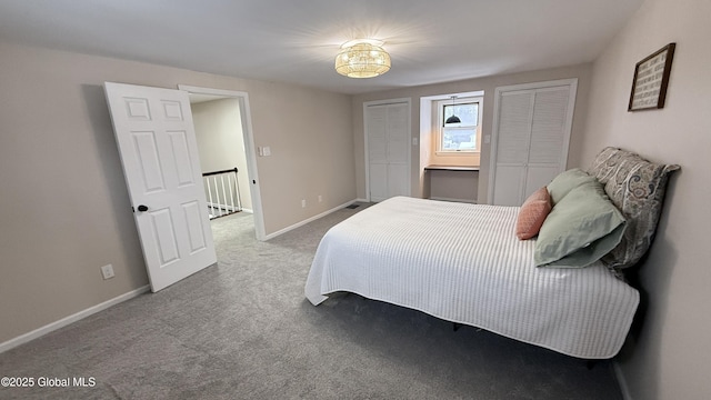 carpeted bedroom with two closets