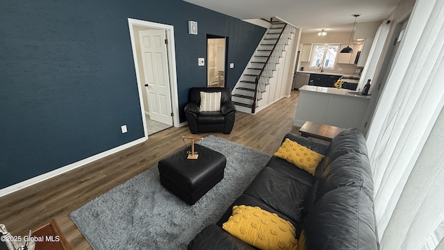 living room with hardwood / wood-style flooring and sink