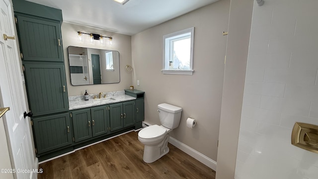 bathroom with hardwood / wood-style flooring, vanity, and toilet