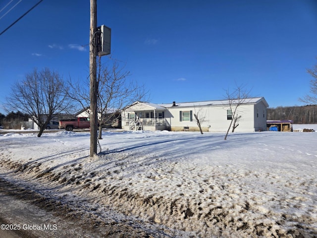 view of snow covered rear of property