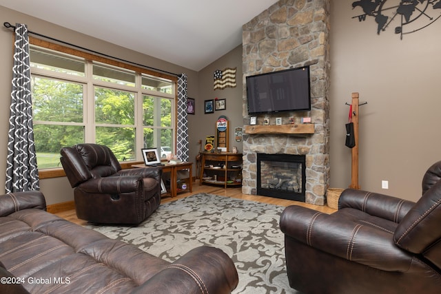 living room with a fireplace, high vaulted ceiling, and wood finished floors