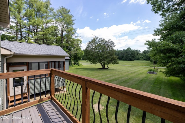 wooden deck featuring a lawn