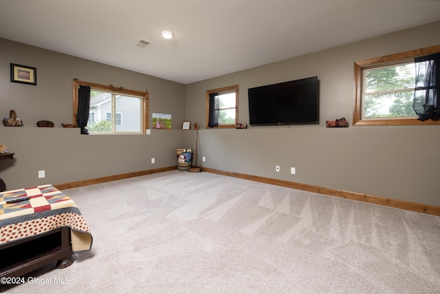 bedroom with visible vents, baseboards, and light colored carpet