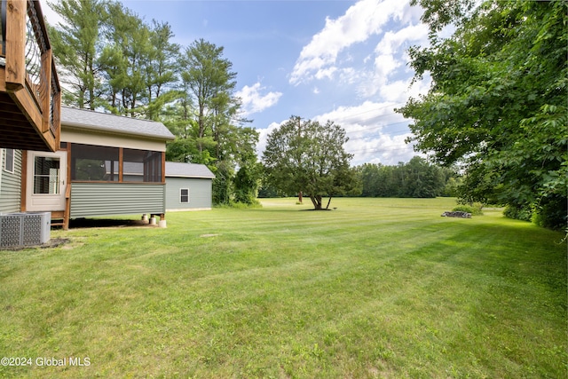 view of yard featuring cooling unit and a sunroom