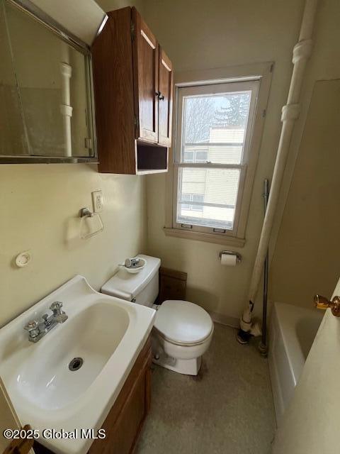 bathroom with toilet, sink, and a washtub