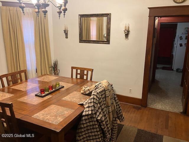 dining room featuring dark hardwood / wood-style flooring and a chandelier