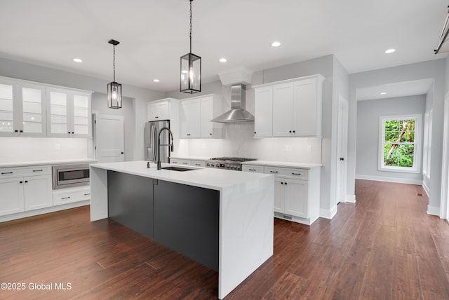 722 Swaggertown Rd, Glenville, NY 12302 - kitchen with wall chimney exhaust hood, a sink, appliances with stainless steel finishes, an island with sink, and white cabinets