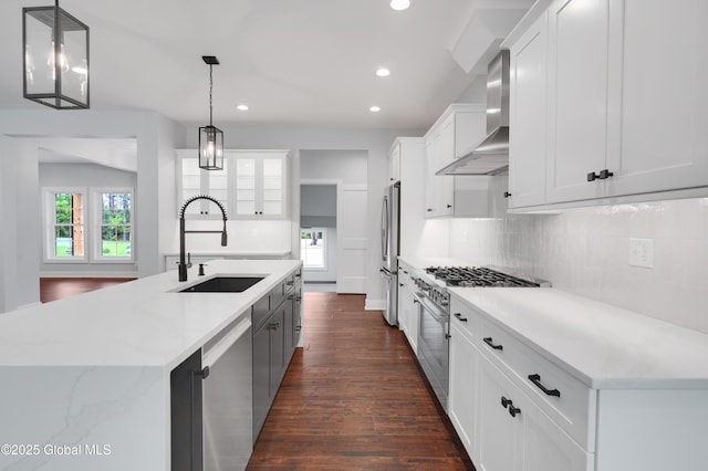 722 Swaggertown Rd, Glenville, NY 12302 - kitchen with wall chimney exhaust hood, stainless steel appliances, a sink, dark wood finished floors, and backsplash