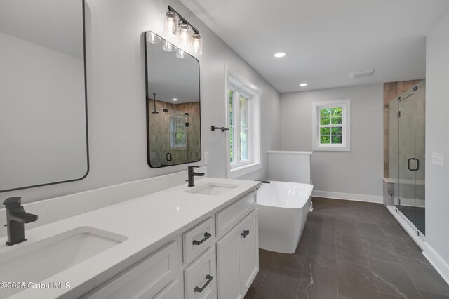 722 Swaggertown Rd, Glenville, NY 12302 - full bath featuring a stall shower, a freestanding tub, double vanity, recessed lighting, and baseboards