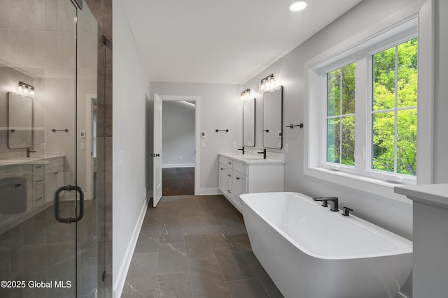 722 Swaggertown Rd, Glenville, NY 12302 - full bath with healthy amount of natural light, a freestanding tub, vanity, baseboards, and recessed lighting