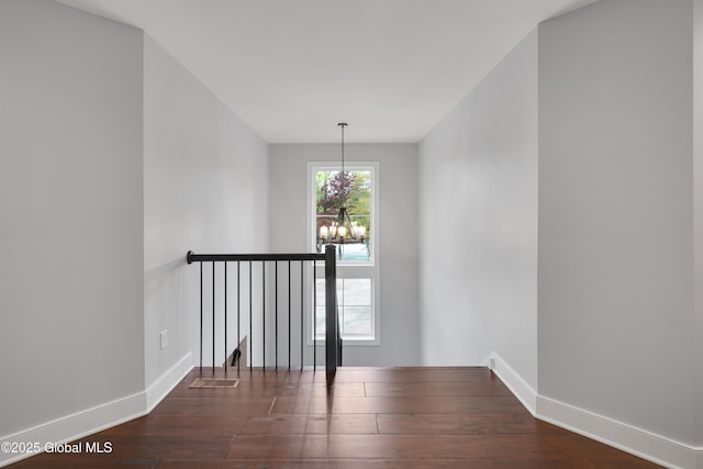 722 Swaggertown Rd, Glenville, NY 12302 - spare room featuring a chandelier, dark wood-type flooring, and baseboards