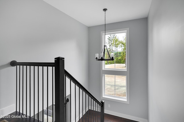 722 Swaggertown Rd, Glenville, NY 12302 - stairway featuring a chandelier, healthy amount of natural light, baseboards, and wood finished floors