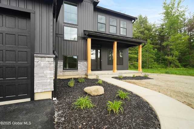 722 Swaggertown Rd, Glenville, NY 12302 - property entrance featuring board and batten siding, a porch, and stone siding