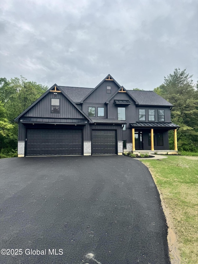 722 Swaggertown Rd, Glenville, NY 12302 - view of front of property featuring a standing seam roof, board and batten siding, asphalt driveway, and a shingled roof