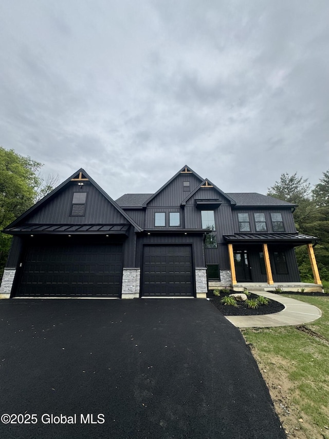722 Swaggertown Rd, Glenville, NY 12302 - view of front of property featuring driveway, an attached garage, board and batten siding, a standing seam roof, and stone siding