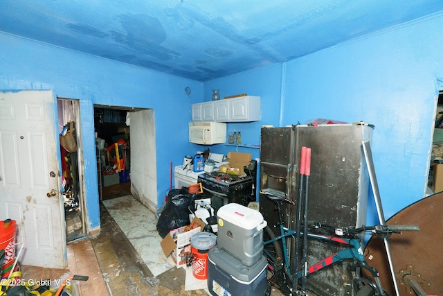 interior space with white cabinetry and fridge with ice dispenser