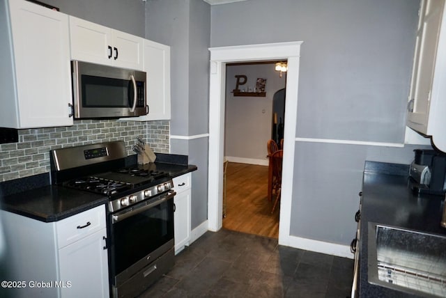 kitchen with tasteful backsplash, stainless steel appliances, and white cabinets