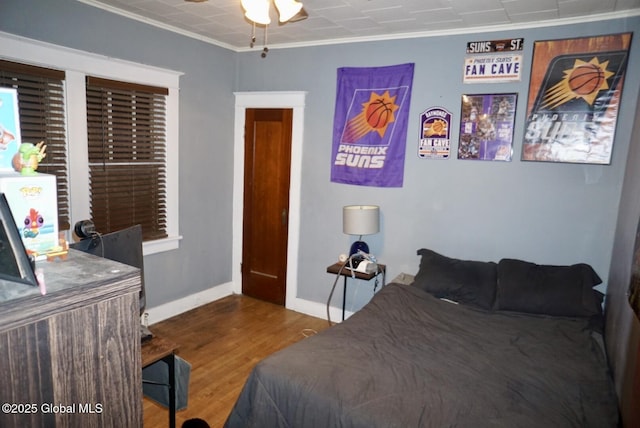 bedroom featuring ornamental molding and hardwood / wood-style floors