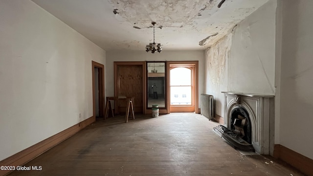 miscellaneous room with radiator heating unit and hardwood / wood-style floors