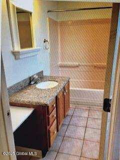 bathroom with vanity, tile patterned flooring, and walk in shower