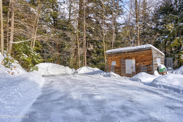 snow covered structure with an outdoor structure