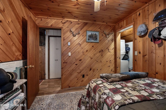 bedroom featuring wood finished floors, wooden walls, and wooden ceiling