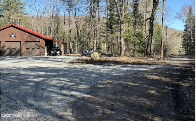 view of street featuring a view of trees and driveway
