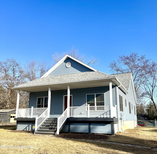 bungalow-style home featuring covered porch and roof with shingles