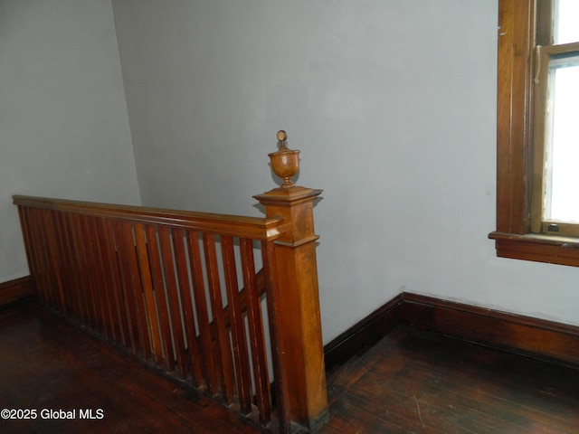 stairway featuring wood-type flooring and plenty of natural light