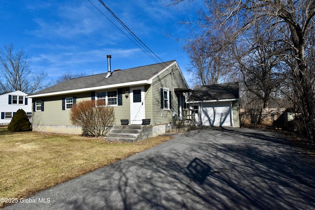 view of front of house featuring driveway, a front lawn, roof with shingles, an outdoor structure, and an attached garage