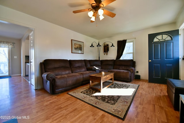 living area featuring a ceiling fan and wood finished floors