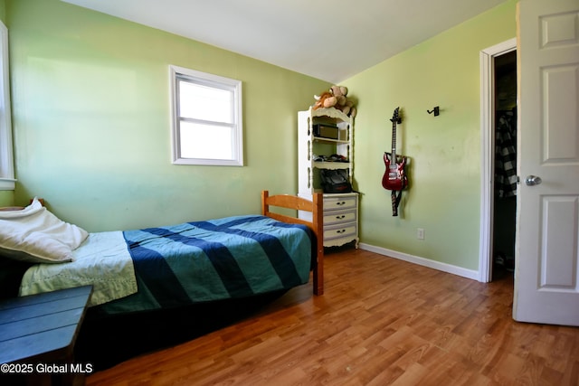 bedroom featuring baseboards and light wood-type flooring