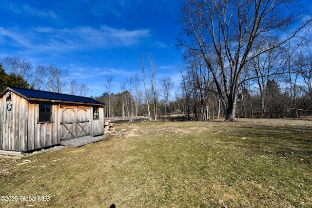 view of yard with an outbuilding and a shed