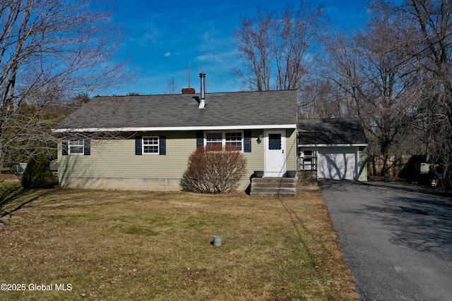 view of front of property with driveway, an outdoor structure, a front yard, a shingled roof, and a garage