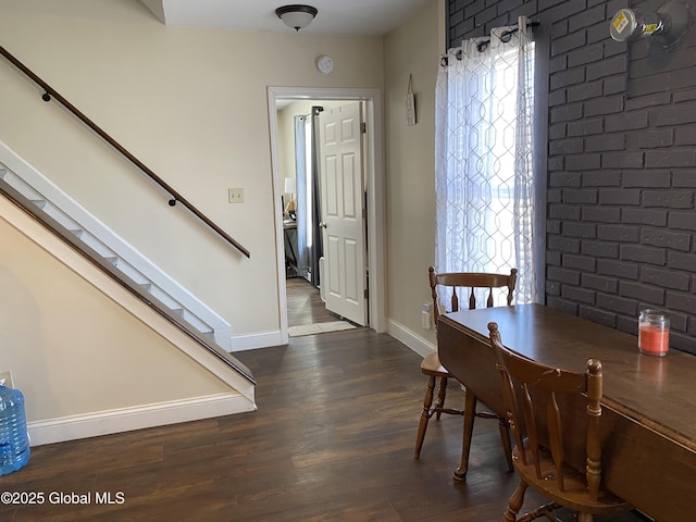 dining space featuring stairway, wood finished floors, and baseboards