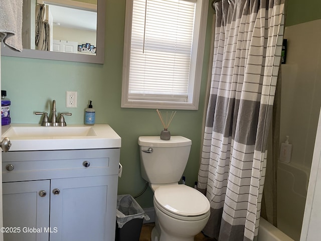 bathroom featuring toilet, curtained shower, and vanity