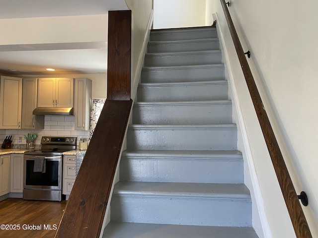 stairs featuring wood finished floors