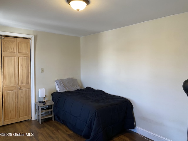 bedroom with baseboards and dark wood-style flooring