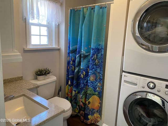 washroom featuring stacked washer / dryer, laundry area, and a sink