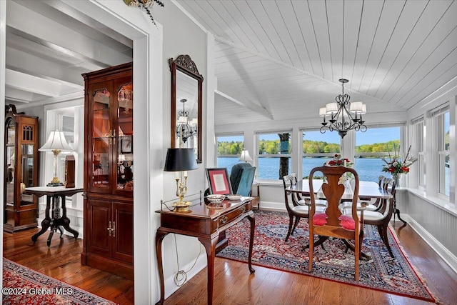 sunroom with a water view, vaulted ceiling, an inviting chandelier, and wooden ceiling