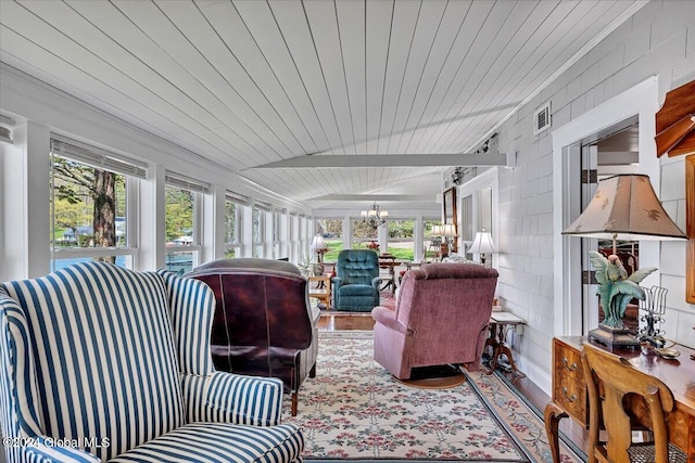 sunroom featuring vaulted ceiling, wood ceiling, and an inviting chandelier