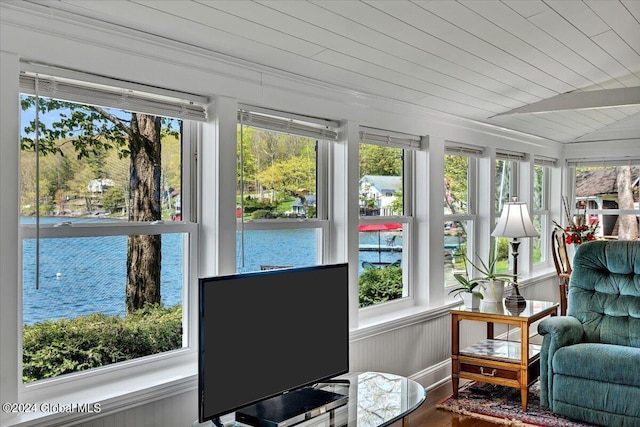 sunroom / solarium with vaulted ceiling, a wealth of natural light, and wood ceiling